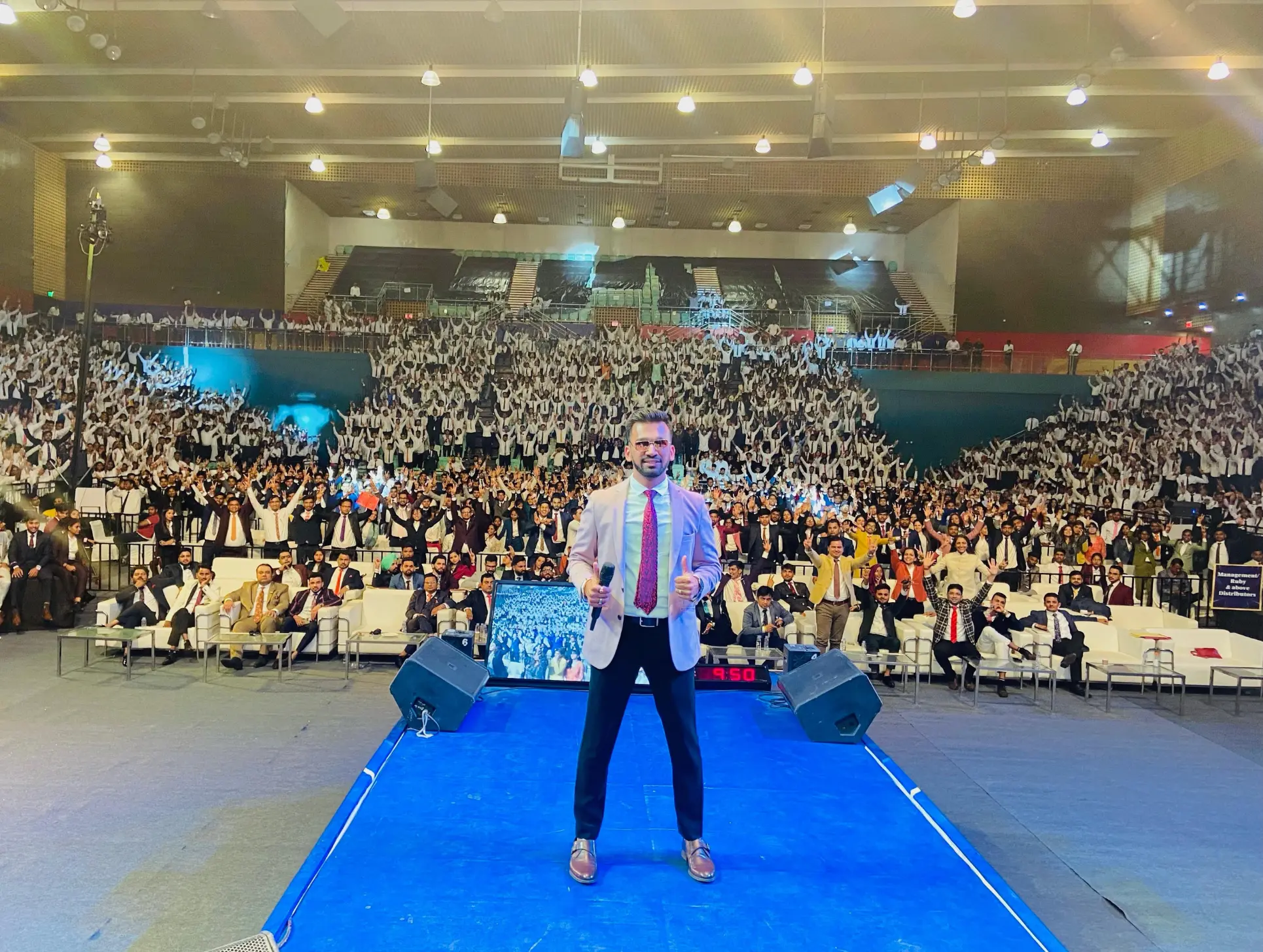 Gautam Jain on stage with thousands of attendees
